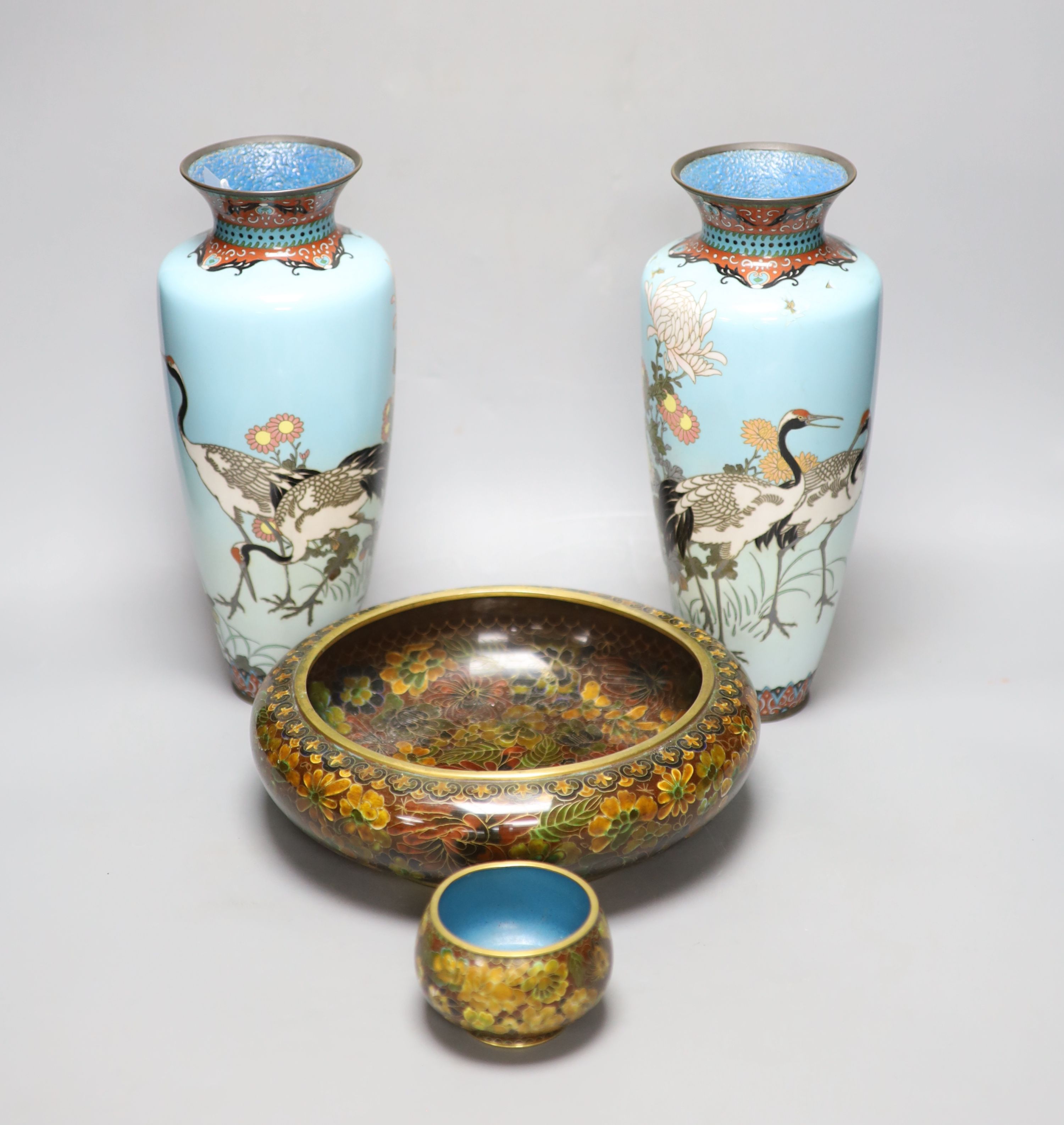 A pair of Japanese turquoise ground cloisonne enamel vases, a large cloisonne bowl and smaller matching bowl, tallest 31cm